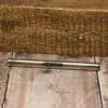 A wooden floor with a pen laying on it