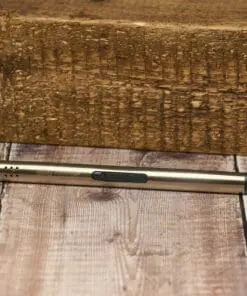 A wooden floor with a pen laying on it