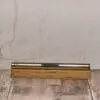 A wooden box with a metal pen on top of it.