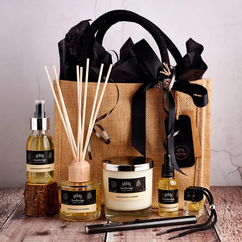 A bag of gifts with candles, diffuser and other items.