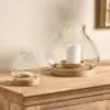 Naryla lantern with a recycled glass bulb shape that sits perfectly in a solid mango wood base