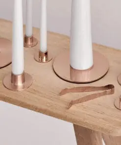 A wooden table with candles on top of it.