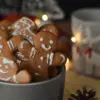 A bowl of gingerbread cookies sitting on top of a table.