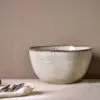 Malia Serving Bowl - Cream by Nkuku, a large 3100ml cream stoneware serving bowl with rounded shape, hand-painted rim detail and soft reactive glaze.