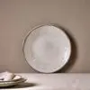 Malia Side Plate - Cream by Nkuku styled in a table setting, showing the 22.5cm plate size, neutral cream glaze and relaxed stoneware finish.