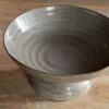 Close-up of the Valinha Earthenware Footed Bowl - Grey by Nkuku, showing the textured earthenware surface, spiral detail and tonal variation in the grey glaze.