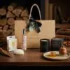 Dark Honey & Tobacco Candle & Skin Care Gift Set – Everyday Treat styled in a warm luxury setting with rich amber and wood tones.