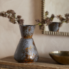 Brija Vase in Brown by Nkuku styled with flowers, featuring a rich reactive glaze and softly textured finish.