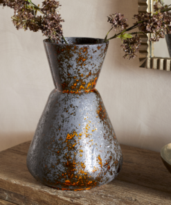 Brija Vase in Brown by Nkuku styled with flowers, featuring a rich reactive glaze and softly textured finish.