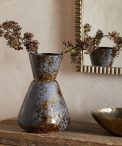 Brija Vase in Brown by Nkuku styled with flowers, featuring a rich reactive glaze and softly textured finish.