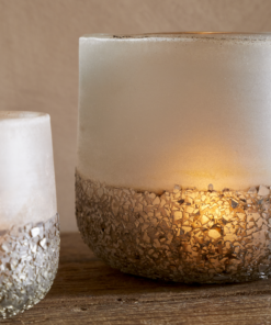 Riyara Recycled Glass Tealight Holder in Silver Sparkle by Nkuku styled and lit for a warm atmospheric effect.