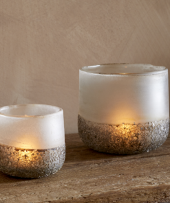 Riyara Recycled Glass Tealight Holder in Silver Sparkle by Nkuku styled and lit for a warm atmospheric effect.
