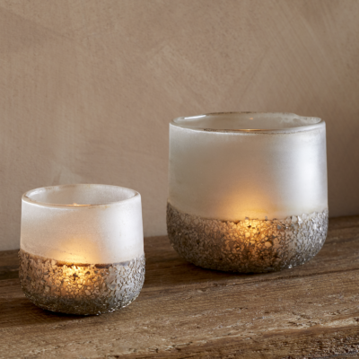 Riyara Recycled Glass Tealight Holder in Silver Sparkle by Nkuku styled and lit for a warm atmospheric effect.