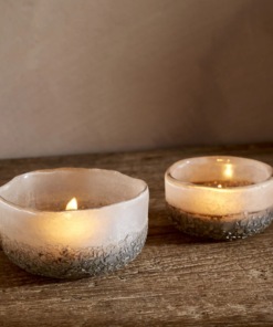 Riyara Recycled Glass Tealights in Silver Sparkle by Nkuku lit with candles, creating a soft warm glow through the textured glass.