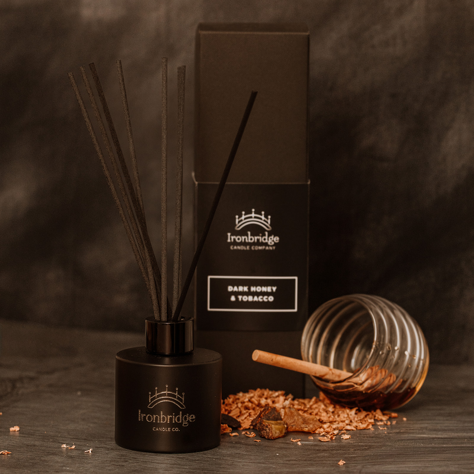 Dark Honey & Tobacco reed diffuser in matt black etched bottle with smoky honey and tobacco fragrance