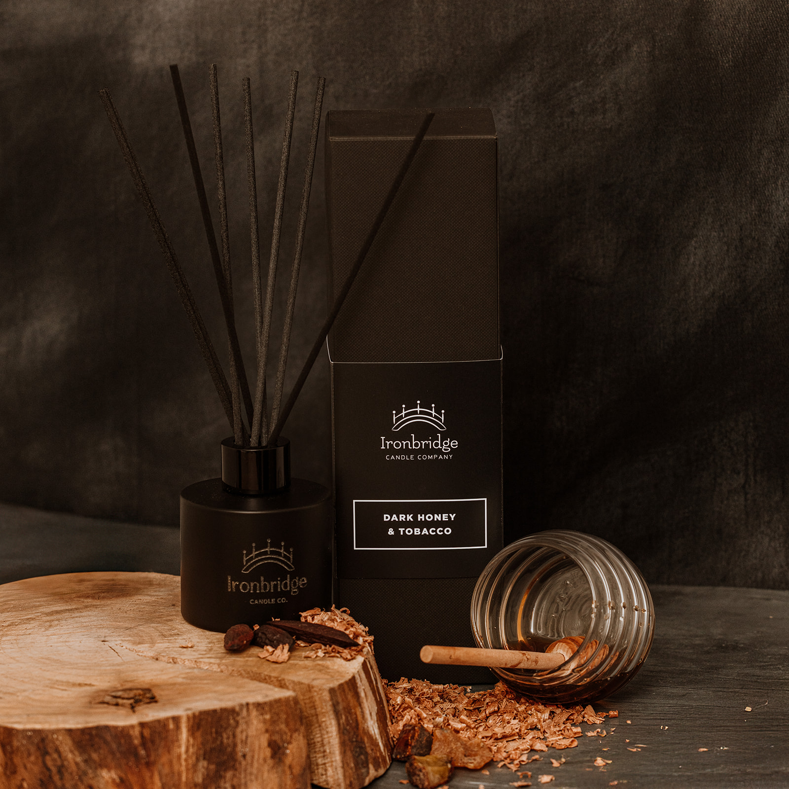 Dark Honey & Tobacco reed diffuser in matt black etched bottle with smoky honey and tobacco fragrance