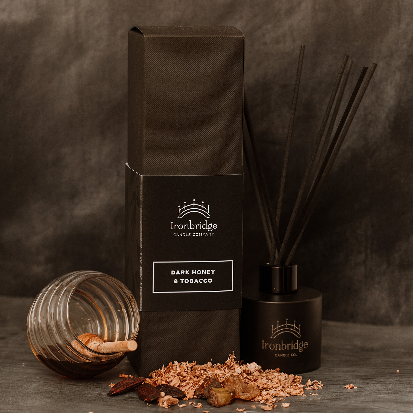 Dark Honey & Tobacco reed diffuser in matt black etched bottle with smoky honey and tobacco fragrance