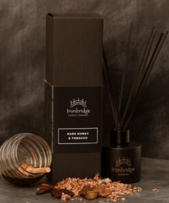Dark Honey & Tobacco reed diffuser in matt black etched bottle with smoky honey and tobacco fragrance