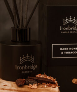 Close-up of Dark Honey & Tobacco reed diffuser in matt black etched bottle