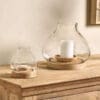 Naryla lantern with a recycled glass bulb shape that sits perfectly in a solid mango wood base