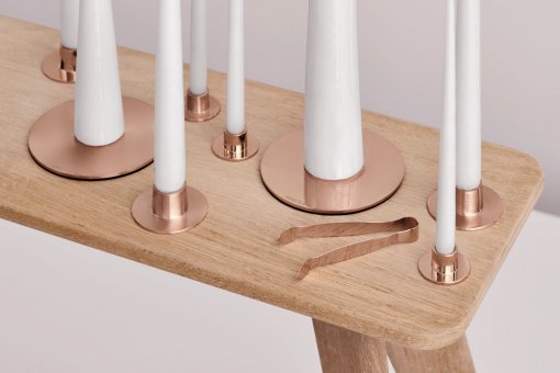 A wooden table with candles on top of it.