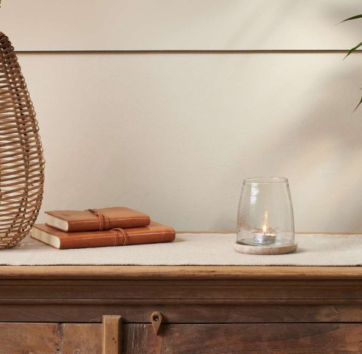 A table with a vase and book on it