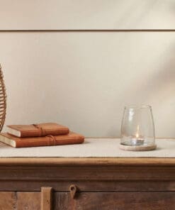 A table with a vase and book on it