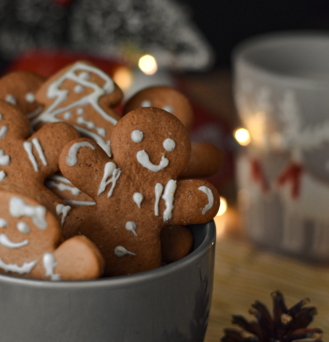 A bowl of gingerbread cookies sitting on top of a table.