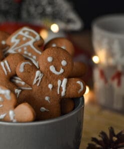A bowl of gingerbread cookies sitting on top of a table.