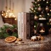 Christmas Wax Melt Collection lifestyle image showing the festive gift box with four full-size seasonal wax melt snap bars, styled with Christmas decorations and warming fragrance ingredients