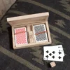 A wooden box with cards and dice on the floor.