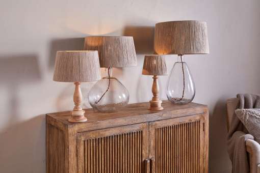 Tiwa Woven Jute Lampshade by Nkuku styled on a lamp base, adding natural woven texture and soft diffused light to the room.