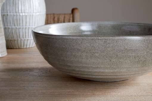 Close-up of the Valinha Earthenware Serving Bowl - Grey by Nkuku, showing the textured spiral pattern, grey earthenware surface and natural tonal variation in the glaze.