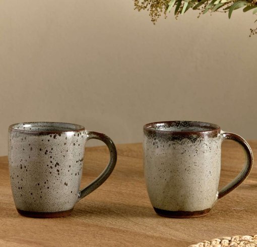 Cam Large Mug - Mocha Set of 2 by Nkuku, showing a matching pair of 350ml ceramic mugs with individual reactive glaze patterns and handcrafted character.