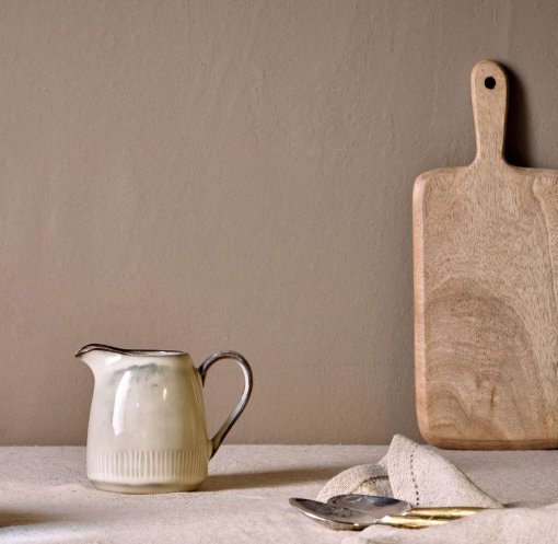 Malia Jug - Cream - Small by Nkuku, a small stoneware serving jug with a soft cream reactive glaze and hand-painted line detail.