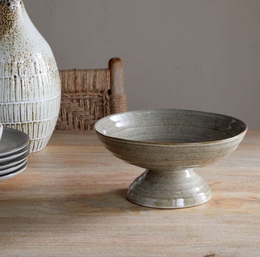 Valinha Earthenware Footed Bowl - Grey by Nkuku, showing the wide shallow bowl shape, raised footed base, textured spiral pattern and layered grey glaze.
