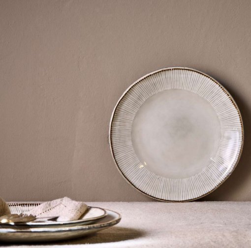 Malia Side Plate - Cream by Nkuku, a 22.5cm cream stoneware side plate with a shallow organic shape, soft reactive glaze and hand-painted rim detail.