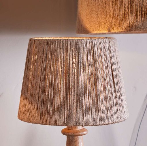Tiwa Woven Jute Lampshade by Nkuku in natural jute, with loose woven fibres, neutral colour and a relaxed rustic texture.