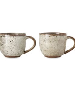 Close-up of the Cam Coffee Mug - Mocha by Nkuku, highlighting the mottled reactive glaze, handmade ceramic texture and warm mocha tones.