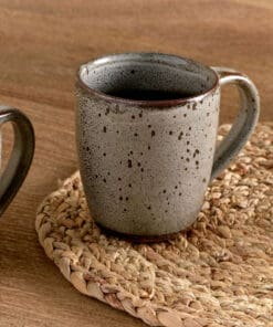 Cam Large Mug - Mocha Set of 2 by Nkuku, showing two large ceramic mugs with warm mocha colouring, a soft mottled reactive glaze and rustic handmade-style finish.