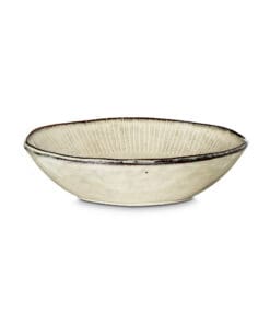 Close-up of the Malia Bowl - Cream by Nkuku, showing the cream stoneware surface, subtle glaze variation and fine hand-painted rim detail.