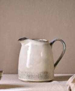 Malia Jug - Cream - Large by Nkuku, 1890ml cream stoneware jug with tall handled shape, curved pouring spout and hand-painted line detail.