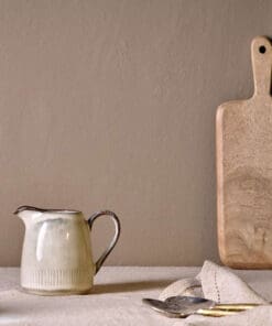 Malia Jug - Cream - Small by Nkuku, a small stoneware serving jug with a soft cream reactive glaze and hand-painted line detail.