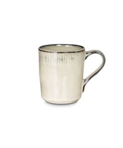 Close-up of the Malia Mug - Cream by Nkuku, showing the cream stoneware surface, textured handle, subtle glaze variation and fine hand-painted line detail.