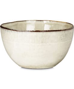 Close-up of the Malia Serving Bowl - Cream by Nkuku, showing the cream stoneware surface, subtle reactive glaze variation and fine hand-painted line detail around the rim.