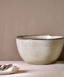 Malia Serving Bowl - Cream by Nkuku, a large 3100ml cream stoneware serving bowl with rounded shape, hand-painted rim detail and soft reactive glaze.