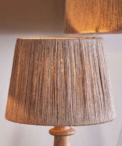 Tiwa Woven Jute Lampshade by Nkuku in natural jute, with loose woven fibres, neutral colour and a relaxed rustic texture.