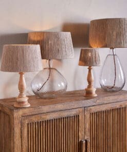 Tiwa Woven Jute Lampshade by Nkuku styled on a lamp base, adding natural woven texture and soft diffused light to the room.