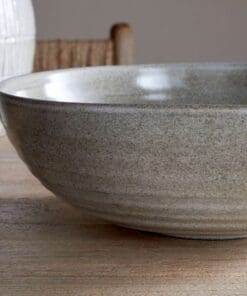 Close-up of the Valinha Earthenware Serving Bowl - Grey by Nkuku, showing the textured spiral pattern, grey earthenware surface and natural tonal variation in the glaze.