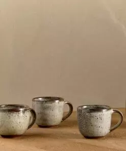 Cam Coffee Mug - Mocha Set of 2 by Nkuku, showing two handcrafted ceramic mugs with a warm mocha colour and soft reactive glaze finish.